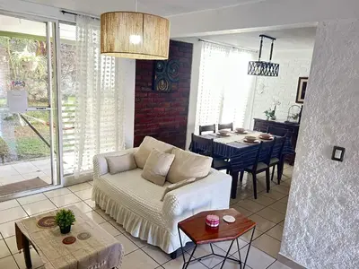 a living room with a couch and a table at ZonaTorre Futura WTC comfy spacious little house! in San Salvador