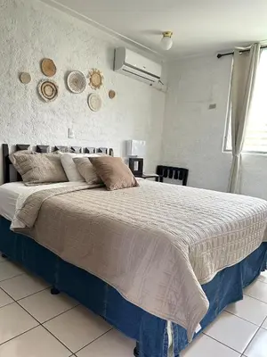 a bedroom with a large bed in a room at ZonaTorre Futura WTC comfy spacious little house! in San Salvador