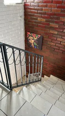 a painting on a wall next to a brick wall at ZonaTorre Futura WTC comfy spacious little house! in San Salvador