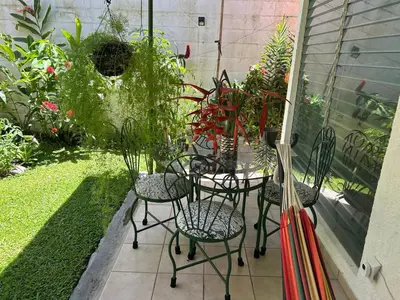 a patio with chairs and plants in a garden at ZonaTorre Futura WTC comfy spacious little house! in San Salvador