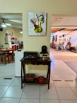a table in a room with a picture on the wall at La Joyona, Cozy House, Atiquizaya
