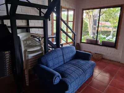 a blue couch in a living room with windows at Tata Lodge, Los Romero