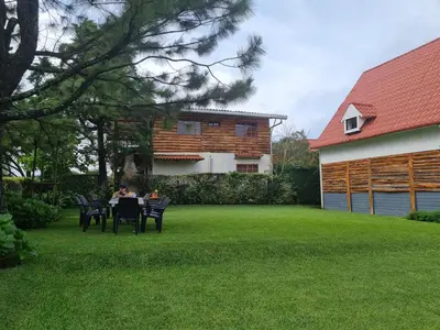 a person sitting at a table in a yard at Tata Lodge, Los Romero