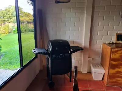 a black chair sitting in a room next to a window at Tata Lodge, Los Romero