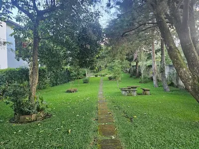 a park with benches and a path in the grass at Tata Lodge, Los Romero
