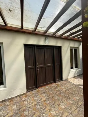 a garage with two wooden doors and a ceiling at Rancho las Arantzas in Jujutla
