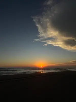 a sunset on a beach with the ocean at Rancho las Arantzas in Jujutla