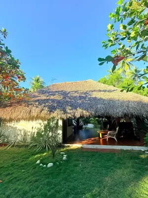 a hut with a thatched roof and a yard at Rancho las Arantzas in Jujutla