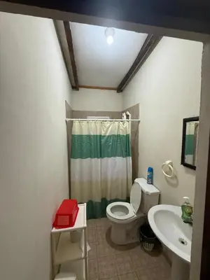 a bathroom with a toilet and a sink at Rancho las Arantzas in Jujutla
