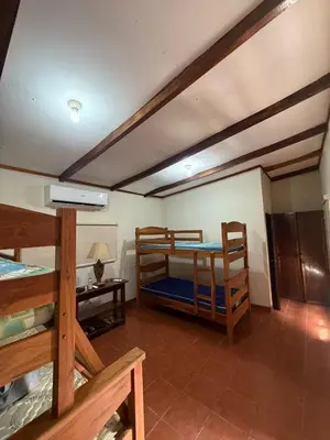 a room with two bunk beds and a table at Rancho las Arantzas in Jujutla