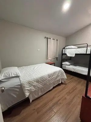 a bedroom with two bunk beds and a wooden floor at Quinta Los 3 Tesoros