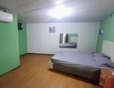 a bedroom with a bed in a room with green walls at Noche de luna in San Salvador