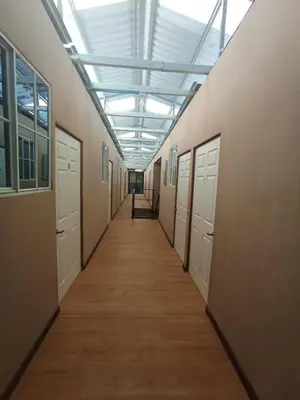 a hallway with white doors and a ceiling at Noche de luna in San Salvador