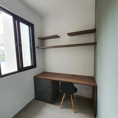 a desk and a chair in a room with a window at Tuscania 203 in Zaragoza