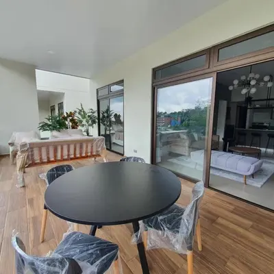 a living room with a black table and chairs at Tuscania 203 in Zaragoza