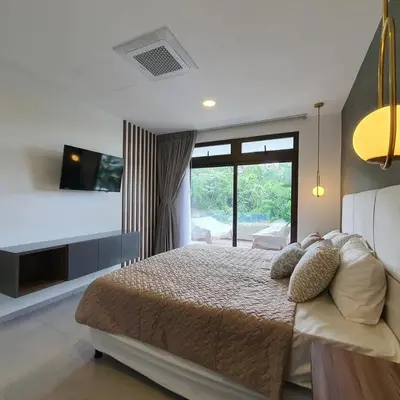 a bedroom with a large bed and a television at Tuscania 203 in Zaragoza