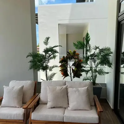 a living room with a couch and some plants at Tuscania 203 in Zaragoza