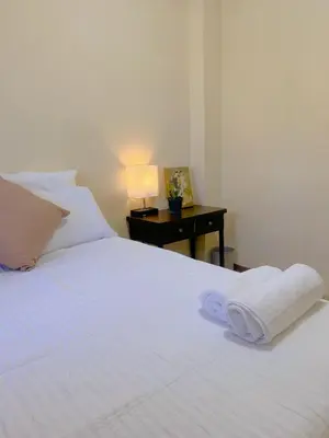 a white bed with a towel on top of it at Uong Oasis in San Salvador