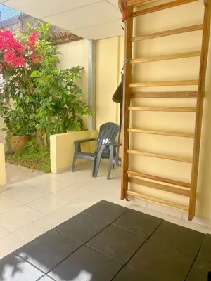 a stairway to a patio with a chair and flowers at Uong Oasis in San Salvador