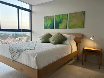 a bedroom with a bed and a large window at Premium comfy apartment Avitat Link, San Salvador in San Salvador