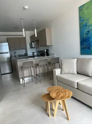 a living room and kitchen with a couch and a table at Premium comfy apartment Avitat Link, San Salvador in San Salvador
