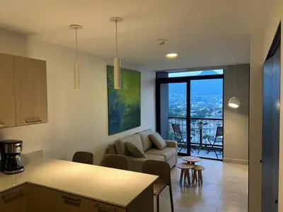 a kitchen and living room with a couch and a table at Premium comfy apartment Avitat Link, San Salvador in San Salvador