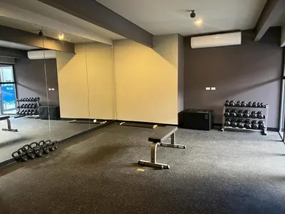 an empty gym with a large room with weights at Premium comfy apartment Avitat Link, San Salvador in San Salvador