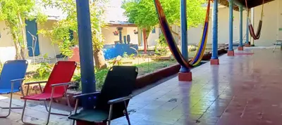 a group of chairs sitting on a porch at La Casona en el Corazon de San Miguel in San Miguel
