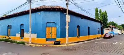 a blue and yellow building on the side of a street at La Casona en el Corazon de San Miguel in San Miguel