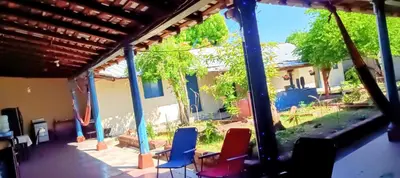 a view of a house with chairs in the yard at La Casona en el Corazon de San Miguel in San Miguel