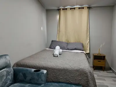 a bedroom with a bed with a teddy bear on it at Apt with 1 Room AC Wi-Fi Kitchen San Salvador in San Salvador