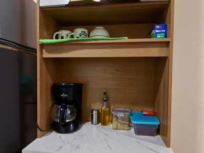 a cupboard with a coffee maker and a blender at Apt with 1 Room AC Wi-Fi Kitchen San Salvador in San Salvador