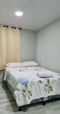 a bedroom with a bed with a blanket on it at Apt with 1 Room AC Wi-Fi Kitchen San Salvador in San Salvador