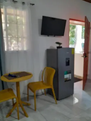 a living room with a small table and a small refrigerator at EL sunzal Bliss #8 in El Sunzal