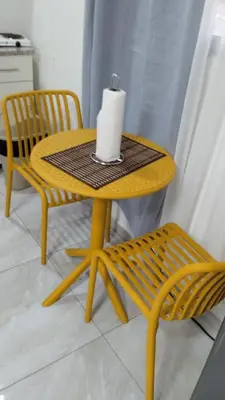 a yellow table with a candle and a chair at EL sunzal Bliss #8 in El Sunzal