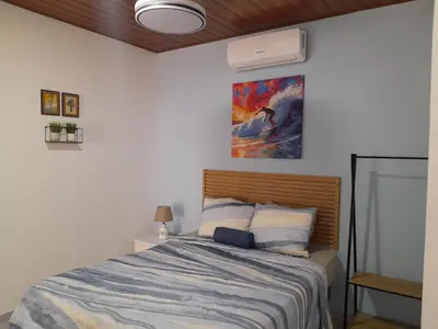 a bedroom with a bed and a painting on the wall at EL sunzal Bliss #8 in El Sunzal