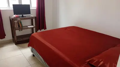a bedroom with a bed and a tv on a table at Family house for 10 guest in Nejapa