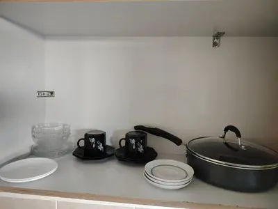 a kitchen counter with a sink and a pot and plates at Family house for 10 guest in Nejapa