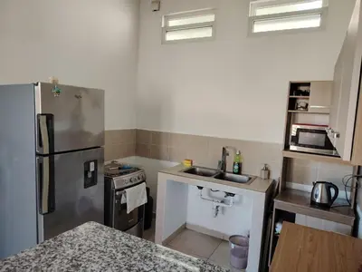 a kitchen with a stainless steel refrigerator and a sink at Family house for 10 guest in Nejapa