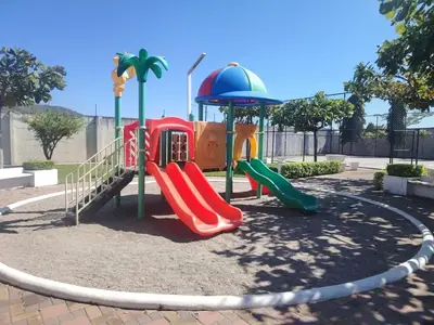 a playground with a slide in a park at Family house for 10 guest in Nejapa