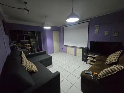a living room with two couches and a projection screen at Apartment with its own 100-inch cinema in Santa Ana