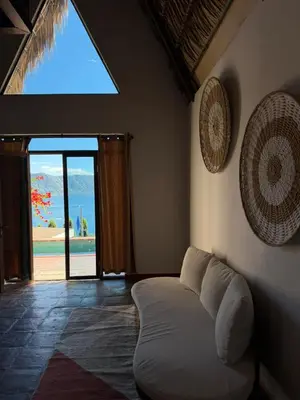 a living room with a white couch and a window at Hotel y Restaurante Buganvilias