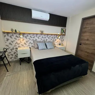 a bedroom with a large bed and two night stands at Casa Bri in Antiguo Cuscatlán
