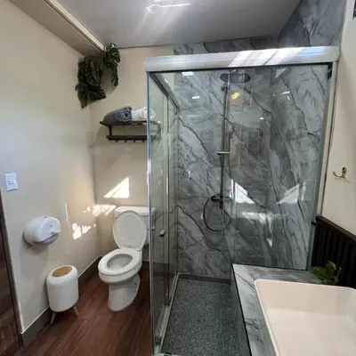 a bathroom with a shower and a toilet and a sink at Casa Bri in Antiguo Cuscatlán