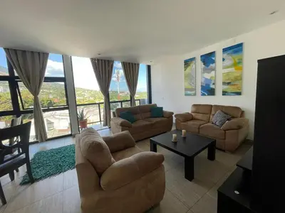 a living room with two couches and a table at Enjoy San Salvador in Torre 91 in San Salvador