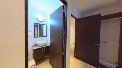 a bathroom with a sink and a mirror at Enjoy San Salvador in Torre 91 in San Salvador