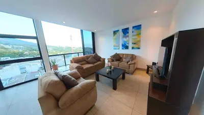 a living room with couches and a flat screen tv at Enjoy San Salvador in Torre 91 in San Salvador