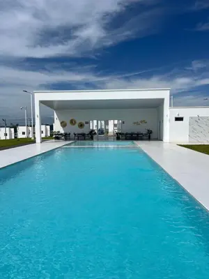a swimming pool in front of a building at Aluna House - Nuevo Sitio del Niño in San Juan Opico