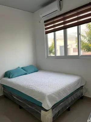 a bed in a white room with a window at Nuevo San Miguel in San Miguel