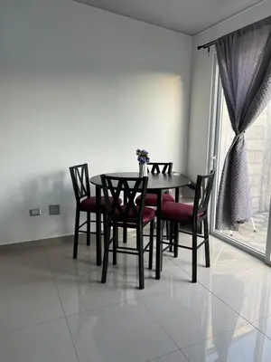 a dining room with a table and chairs and a window at Nuevo San Miguel in San Miguel